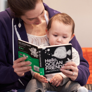 image of mom and baby with book